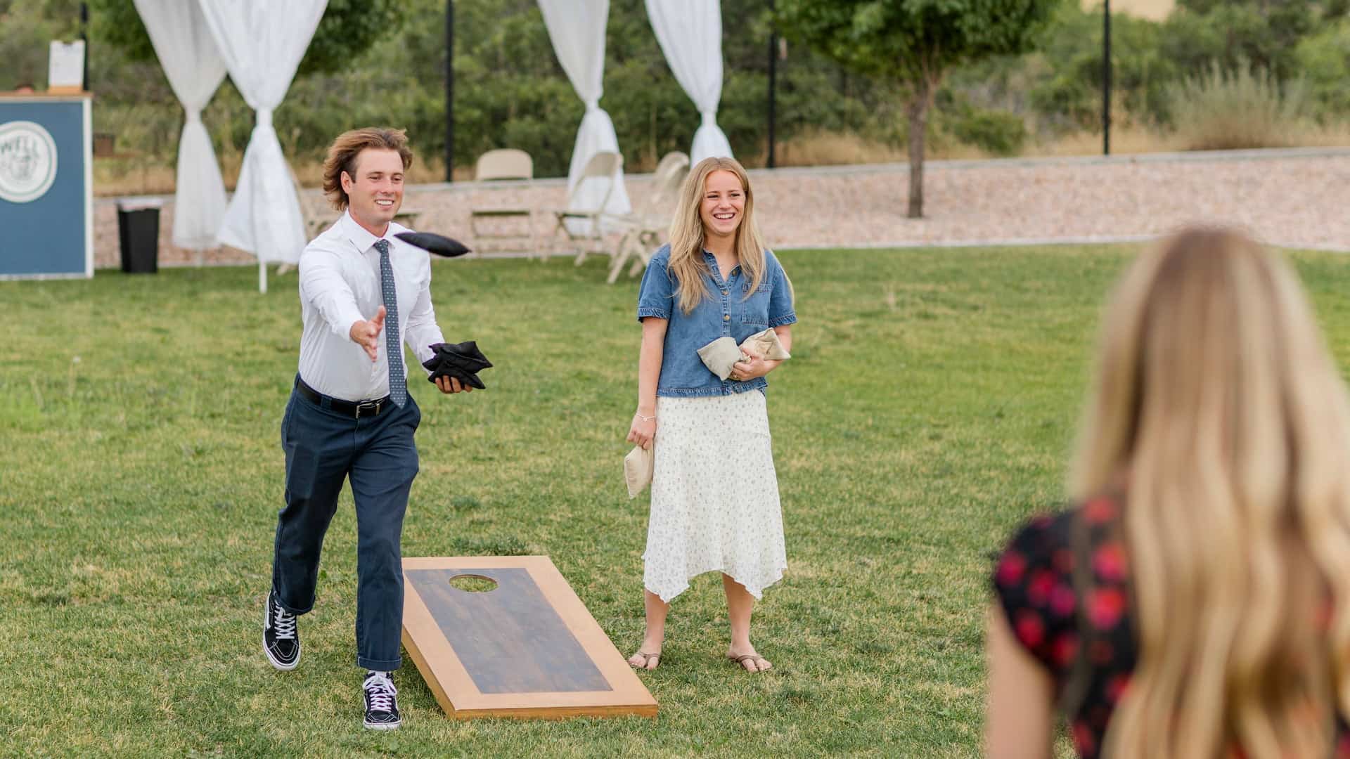 Guests enjoying yard games at sunset