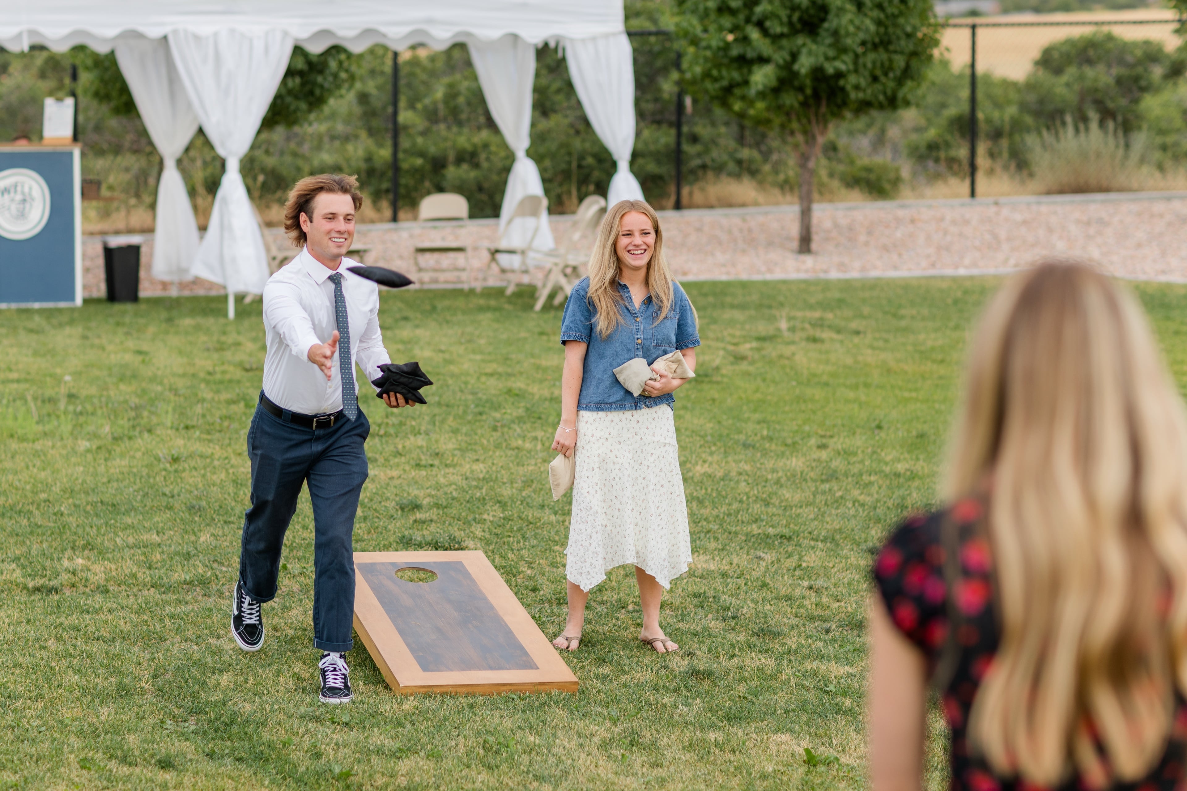 Guests enjoying yard games at sunset